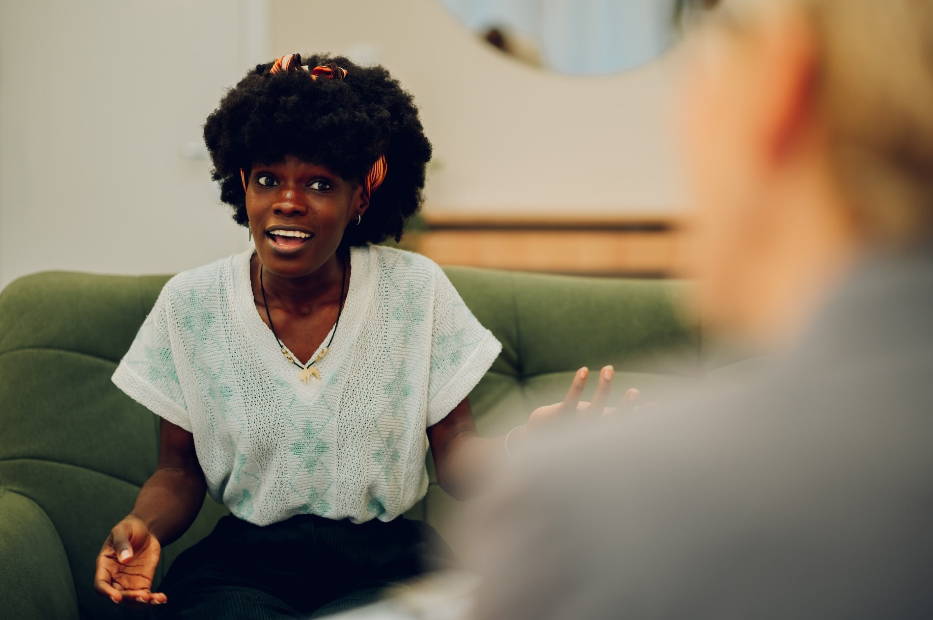 Young woman in individual therapy session expressing emotions during counselling