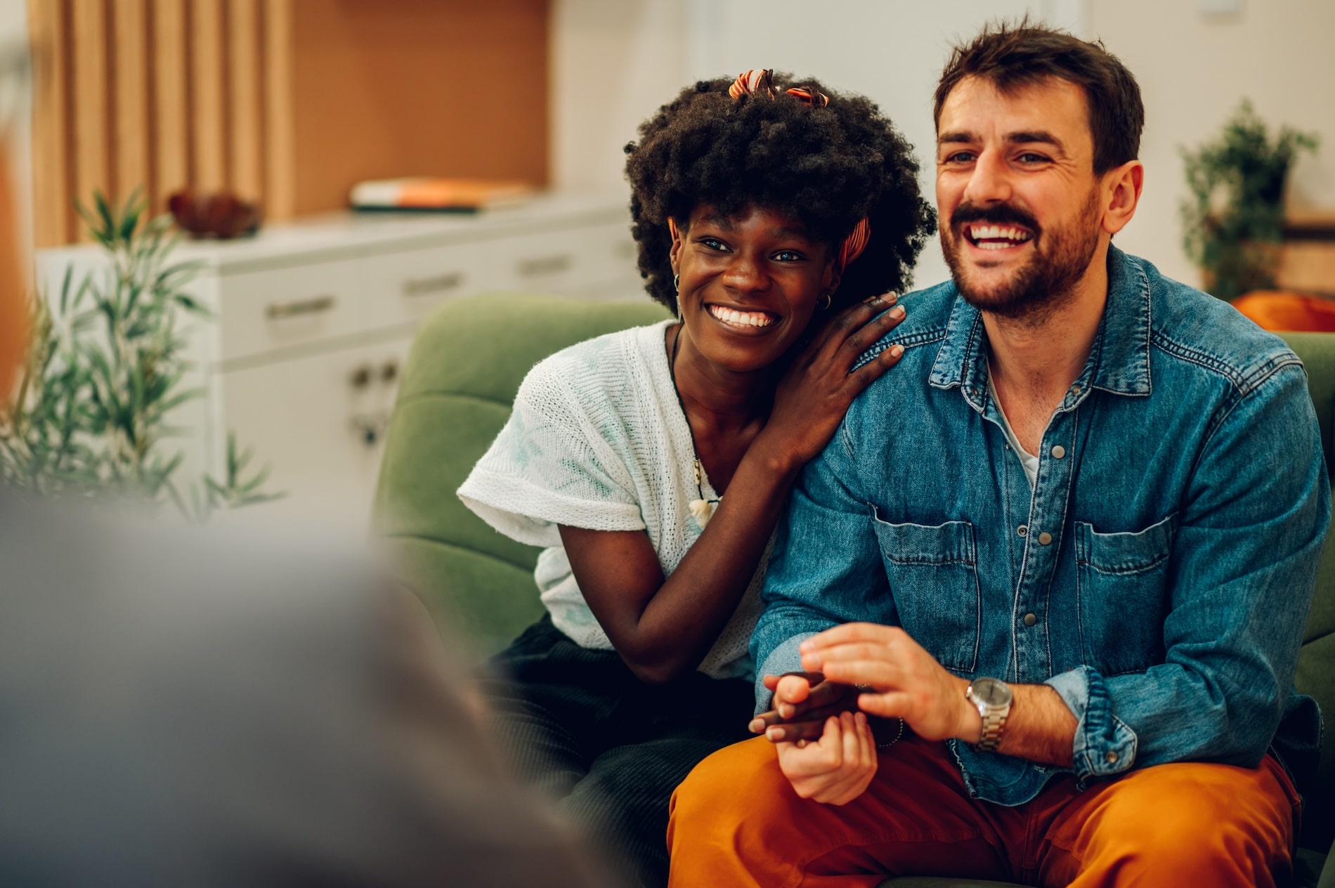 Interracial couple during a joyful moment in a relationship therapy session
